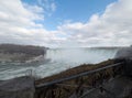 Gulls fly at Niagara falls, mist raises from the falls and blue sky Royalty Free Stock Photo