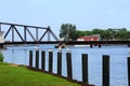 Gulls sit on Wooden Pilings in Front of St. Josephs` Swingbridge Royalty Free Stock Photo