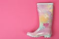 Gumboot on color background, top view