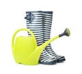 Gumboots with watering can for gardening on white background