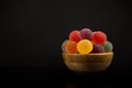 Gumdrops, Colorful Fruit Sugarcoated Marmalade balls in Wooden Bowl. Traditional Scandinavian Christmas Candy Royalty Free Stock Photo