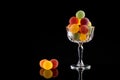 Gumdrops, Colorful Sugarcoated Marmalade balls in crystal glass. Traditional Finnish Christmas Candy, on black background Royalty Free Stock Photo