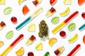 Among gummies of different shapes, flavors and colors, a dried cannabis bud