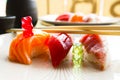 Gummy bears playing on a food table with three sushi nigiris. Royalty Free Stock Photo