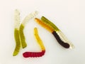 Gummy worms lie on a white matte background. bright, mouth-watering gelatinous worms of different colors. delicious and sweet Royalty Free Stock Photo