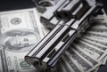 Gun on 100-bucks background Royalty Free Stock Photo