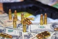 Gun and bullets on dollar and euro banknotes background Royalty Free Stock Photo