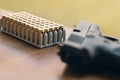 Gun with bullets. Handgun box with new ammunition. Royalty Free Stock Photo