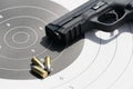 Gun with bullets on the target Royalty Free Stock Photo