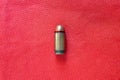 Gun cartridge on red background. Bullet moves vertically. Closeup concept image with copy space Royalty Free Stock Photo