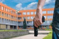 Gun control concept. Young armed man holds pistol in hand in public near school. Royalty Free Stock Photo
