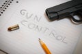 `Gun Control` Scrawled on Notebook with Pistol