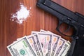 Gun, drugs and money on wooden background. Top view