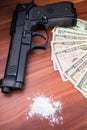 Gun, drugs and money on wooden background. Top view