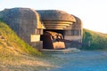 Gun emplacement at Omaha Beach. Bomb shelter with german long-range artillery gun from world war 2 in Longues-sur-Mer in Normandy. Royalty Free Stock Photo