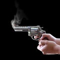 Gun in hand on Black background Royalty Free Stock Photo