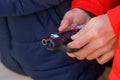 A gun in the hands of a young man, selective focus. Reloading weapons. Shooting training. Background