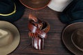 Gun with holster and gunbelt with old west hats on table. Top view Royalty Free Stock Photo