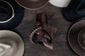 Gun with holster and gunbelt with old west hats on table. Top view Royalty Free Stock Photo