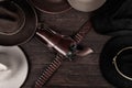 Gun with holster and gunbelt with old west hats on table. Top view Royalty Free Stock Photo