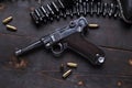 Gun Luger with cartridges and holster on the blackboard