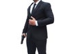 A gun man wearing a black suit is holding a gun in a stalwart pose on white background. Concept for assassin, murder, Royalty Free Stock Photo