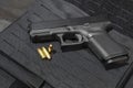 gun and 9mm bullets on a bulletproof jacket