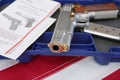 Gun or pistol inlaid with wood and gold and bullet holder in a blue box on a american flag background. weapon concept. protection