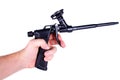 A gun for polyurethane foam in a man hand on a white background Royalty Free Stock Photo