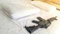 gun Put on a comfortable mattress and pillow white . Royalty Free Stock Photo