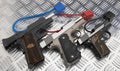 Gun safety , Locked disarmed and secured automatic hand guns on metal background Royalty Free Stock Photo