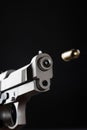 Gun shooting bullet on black background close up Royalty Free Stock Photo