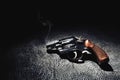 Gun with smoke on the floor, high contrast image Royalty Free Stock Photo