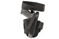 The gun in the tactical on-shin holster. Isolated