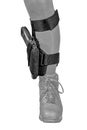 The gun in the tactical on-shin holster. Isolated