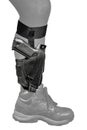 The gun in the tactical on-shin holster. Isolated