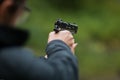 Woman holding a BB Gun ( pistol )