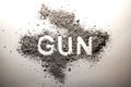 Gun word written in ash as crime, criminal, violence, murder, de