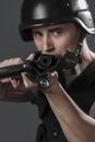 Gunfire, paintball sport player wearing protective helmet aiming Royalty Free Stock Photo