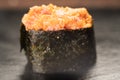 Gunkan Maki Sushi with Seafood, caviar and Spicy Sauce. Spicy gunkan with tuna isolated on black. Delicious Gunkan Sushi Royalty Free Stock Photo