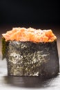 Gunkan Maki Sushi with Seafood, caviar and Spicy Sauce. Spicy gunkan with tuna isolated on black. Delicious Gunkan Sushi Royalty Free Stock Photo