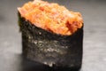 Gunkan Maki Sushi with Seafood, caviar and Spicy Sauce. Spicy gunkan with tuna isolated on black. Delicious Gunkan Sushi Royalty Free Stock Photo