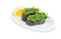 Gunkan sushi with With Hiashi wakame and cucumber with sesame on white plate with gold border. Pan Asian restaurant