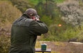 Gunman shooting the asphalt pigeon Royalty Free Stock Photo