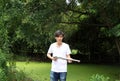 The gunner man holding long gun in hands and turned left sideways with white shirt and denim jean. Royalty Free Stock Photo