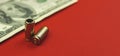 Guns and money, bullet and dollar on red background, criminal and illegal concept, copy space