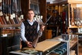 Gunshop seller with a rare collectible hunting rifle in hands Royalty Free Stock Photo