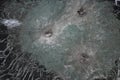 Gunshot marks on bulletproof glass