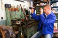 Gunsmith checks telescopic sight in weapons workshop Royalty Free Stock Photo