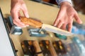 Gunsmith shop assistant demonstrates hunting knife in his hands